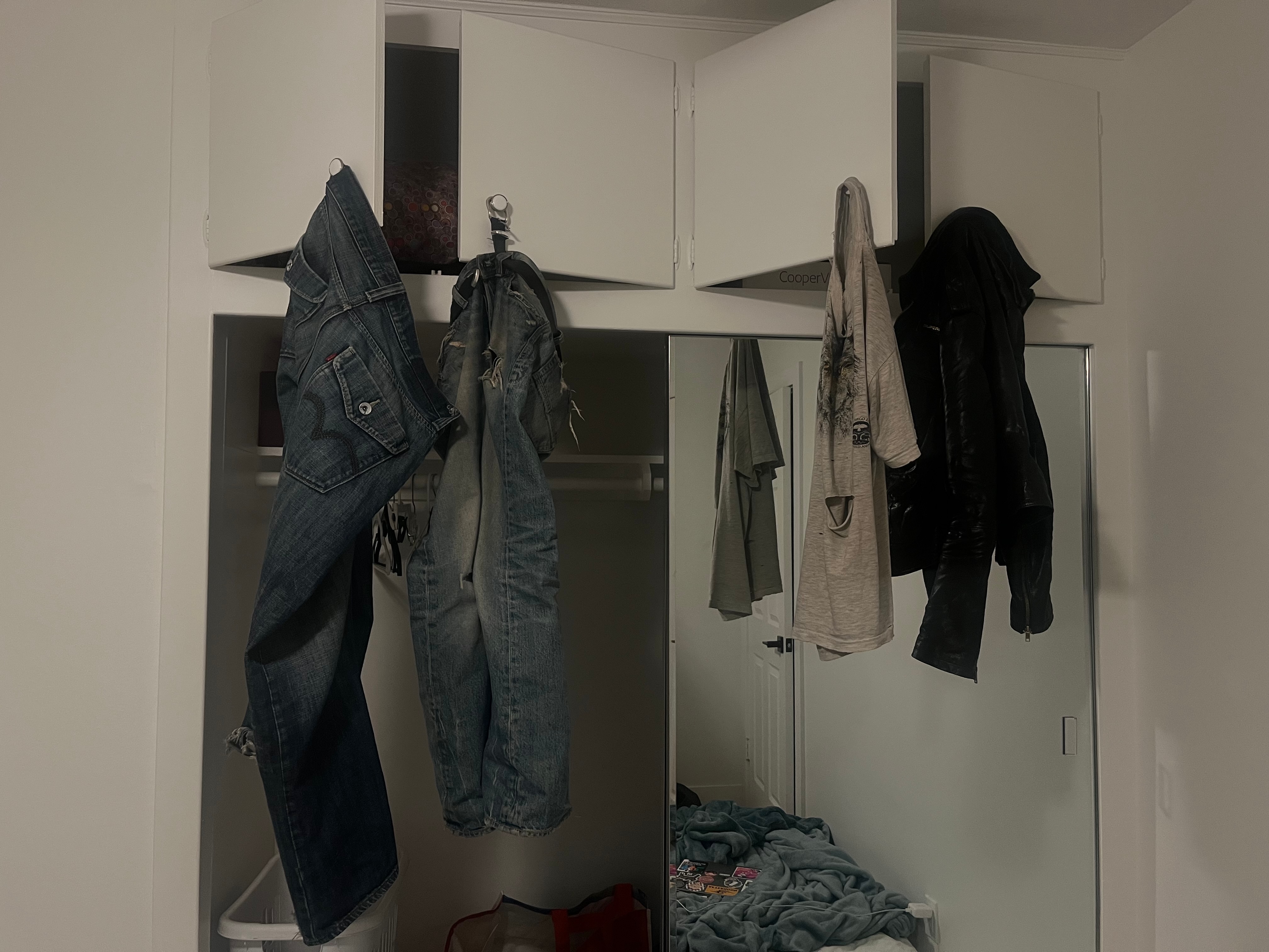 clothes hanging in a dark room