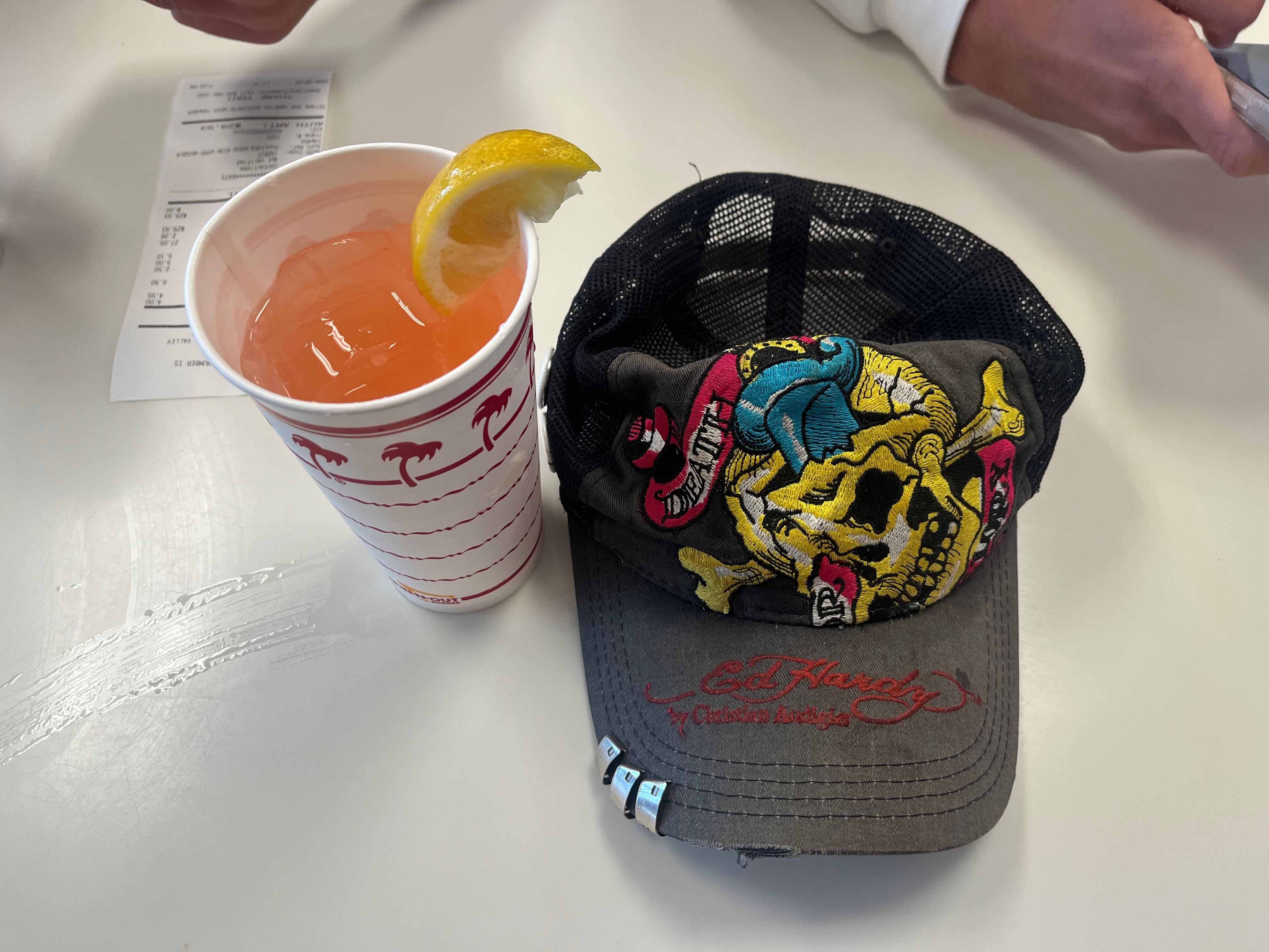 a hat and a soda on the table